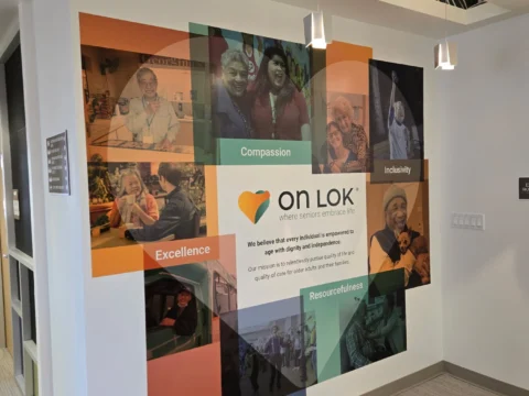 Angled view of a colorful On Lok environmental wall graphic