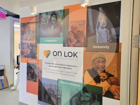 On Lok branded collage graphic installed on a corridor wall