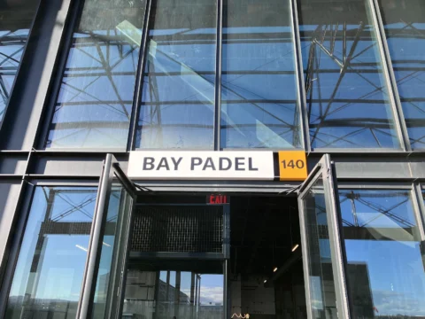 Bay Padel dimensional entrance sign above a glass storefront