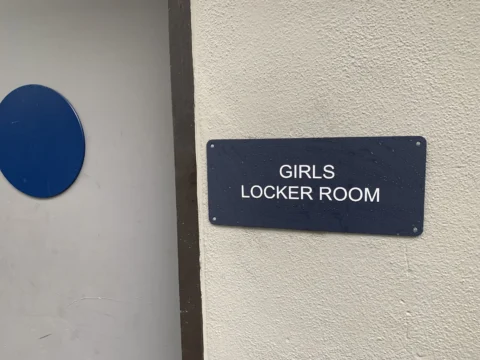 Girls locker room identification sign mounted beside a doorway