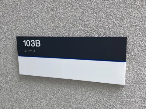 Room 1038 identification plaque on an interior corridor wall