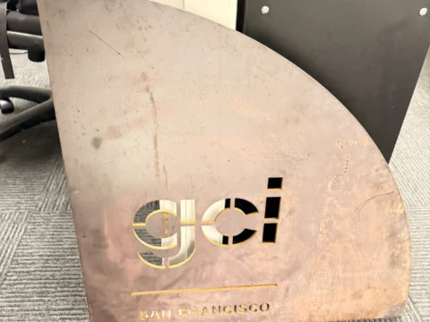 Freestanding GCI metal logo panel shown before installation