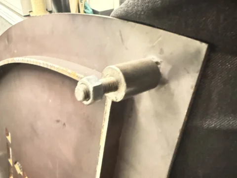 Side detail of a fabricated metal logo sign panel