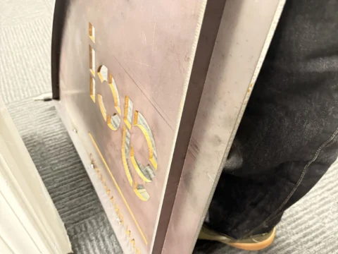 Reverse side and mounting detail of a custom metal sign