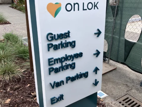 On Lok campus parking and entrance directional monument sign