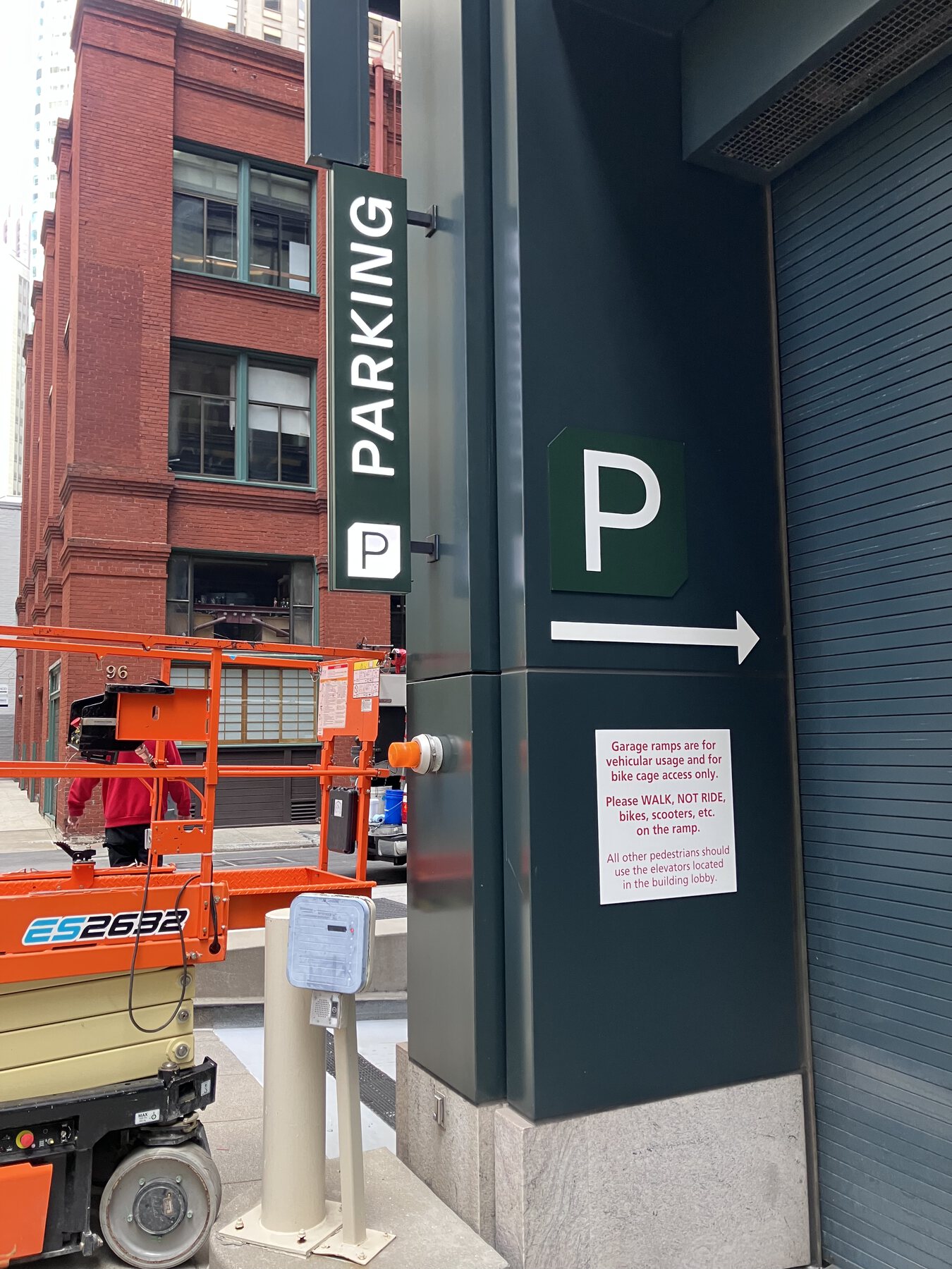 Exterior parking wayfinding sign with directional arrow