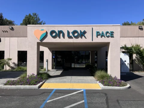 Front view of On Lok PACE exterior building signage