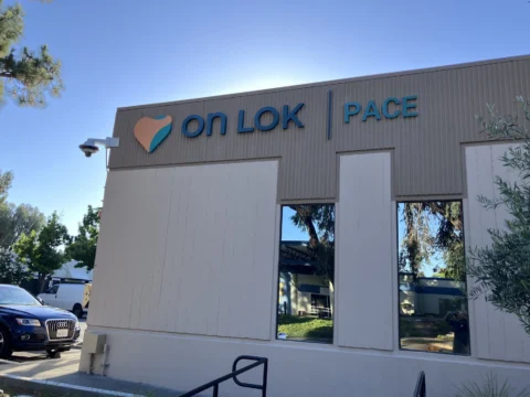 On Lok PACE dimensional logo installed high on an exterior wall