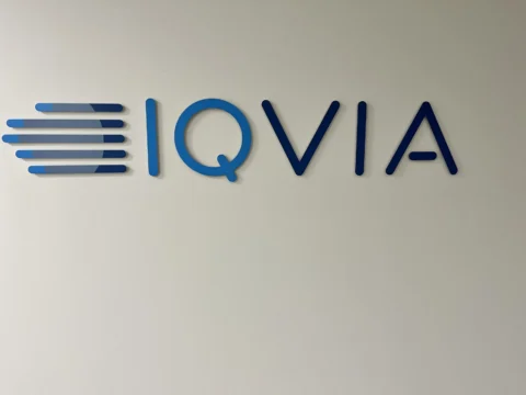 IQVIA dimensional logo and lettering mounted on an interior wall