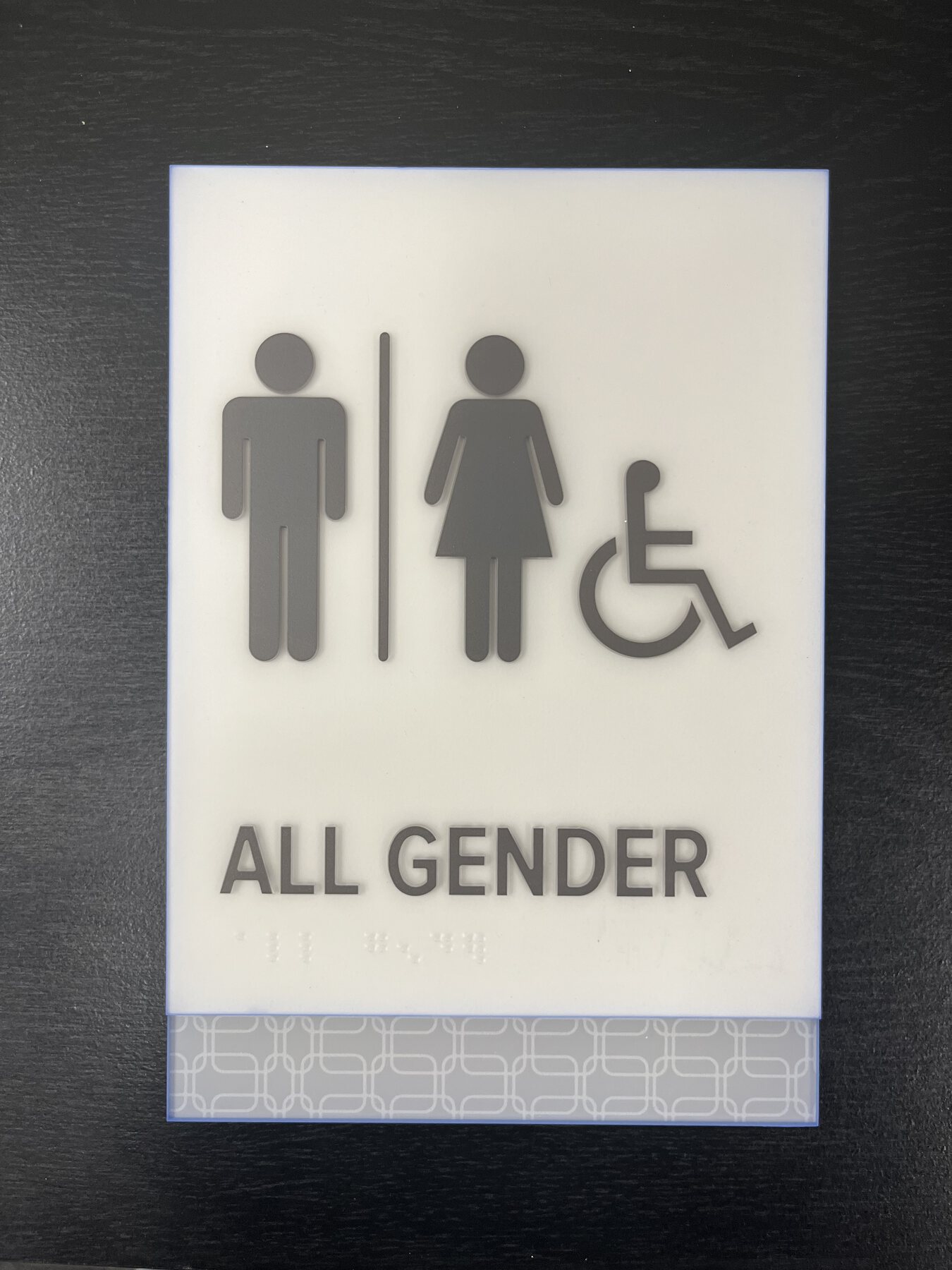 All-gender accessible restroom plaque with tactile symbols