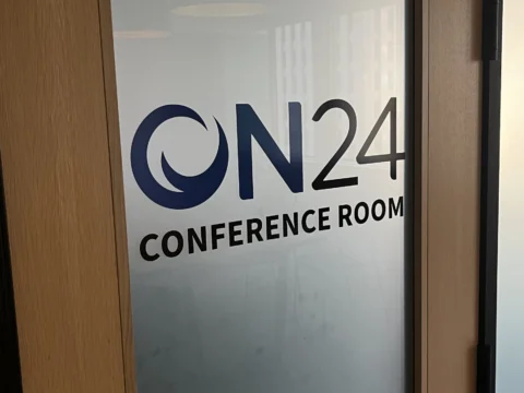 ON24 conference room branding applied to a glass door