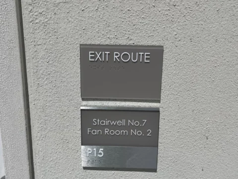 Exit route and room information plaques on an exterior wall