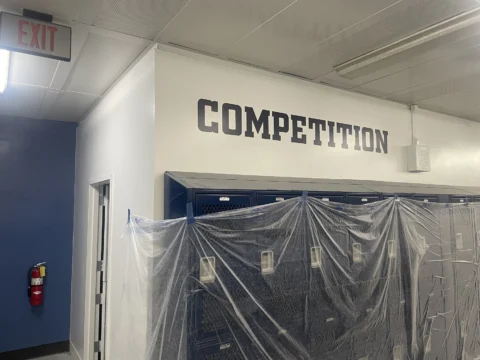 Competition dimensional wall lettering above a protected doorway