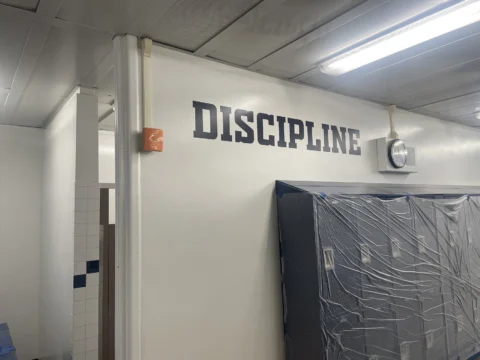 Discipline dimensional letters mounted over a doorway