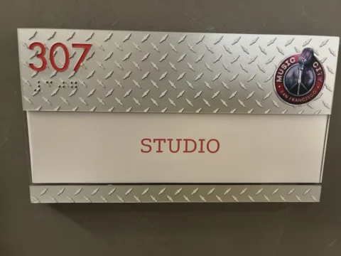Firehouse 307 studio sign with diamond-plate metal accents