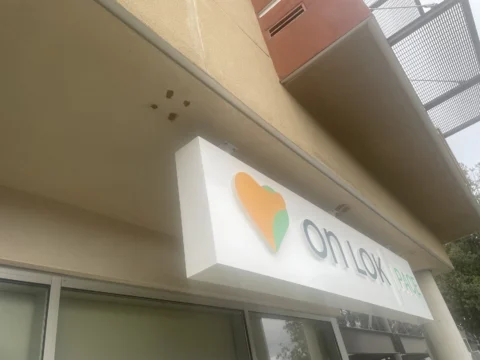 Illuminated On Lok exterior cabinet sign above an entrance