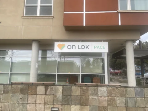 On Lok PACE exterior logo mounted on a multistory building facade
