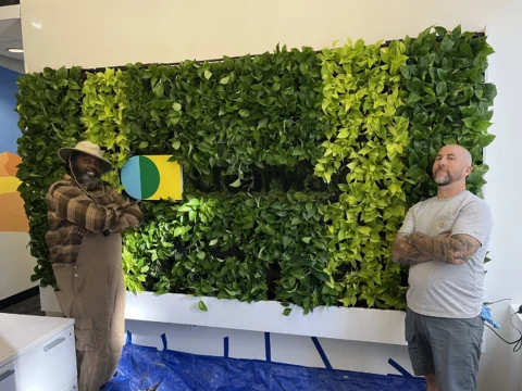 Installation team beside the finished Clearway branded living wall