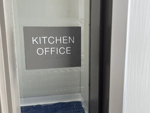 Kitchen office identification sign applied to a glass door