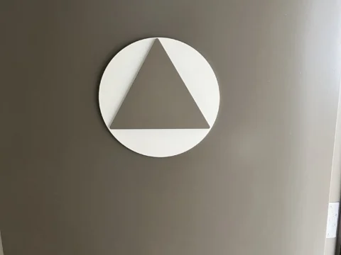 Circular geometric room symbol mounted on an interior door