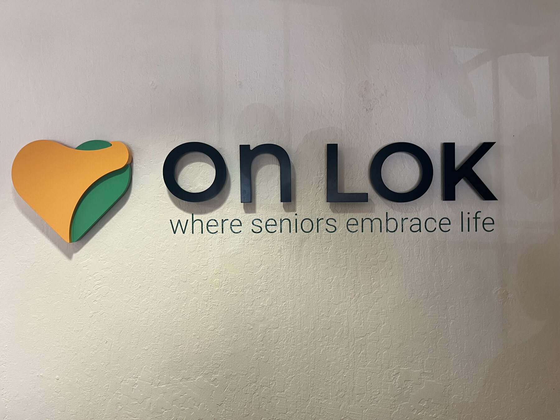 Close view of On Lok interior dimensional lettering and heart logo