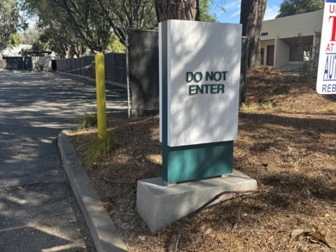 Visitor parking monument sign installed beside a landscaped drive
