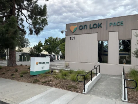 On Lok PACE entrance signage and monument sign viewed from the sidewalk