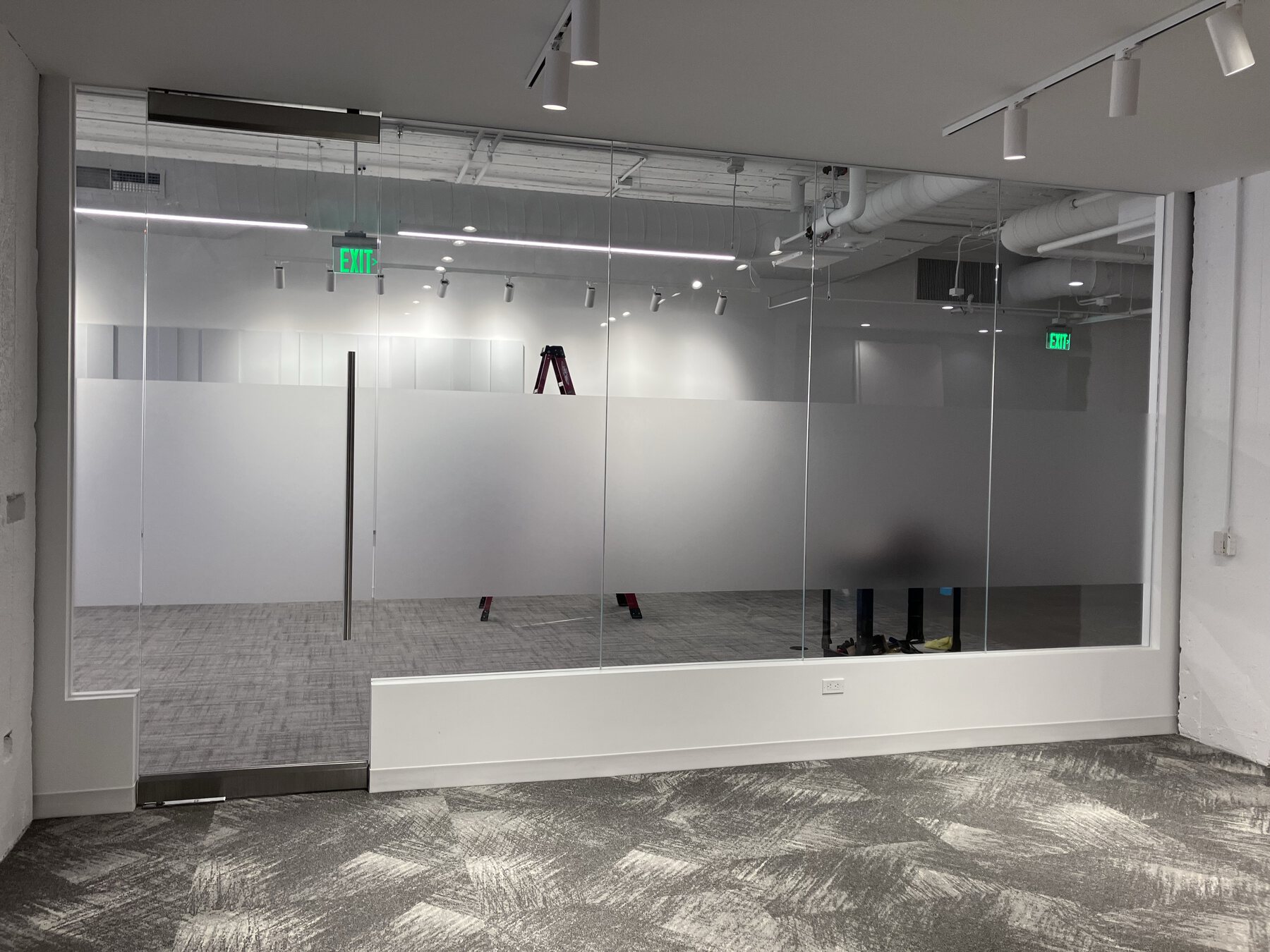 Privacy film installation on glass office and conference room walls