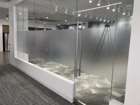 Commercial glass office with professionally installed frosted privacy film
