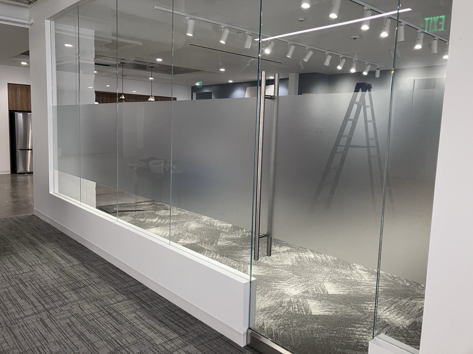 Commercial glass office with professionally installed frosted privacy film