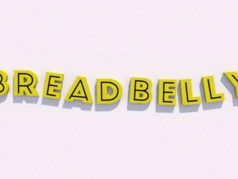 Yellow Breadbelly dimensional letters installed on an interior feature wall