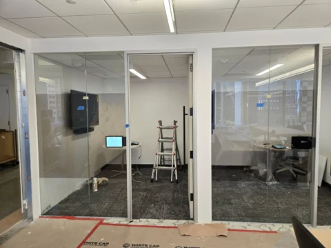 Glass conference room prepared for a privacy film installation