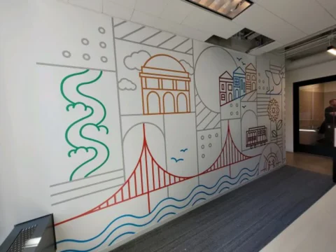 Wide line-art city mural installed along an office corridor wall