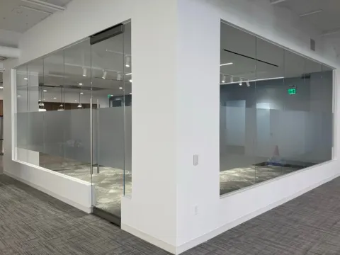 Frosted privacy bands applied around a glass conference room corner