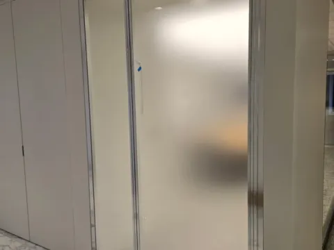 Frosted privacy film covering a glass office door and sidelight