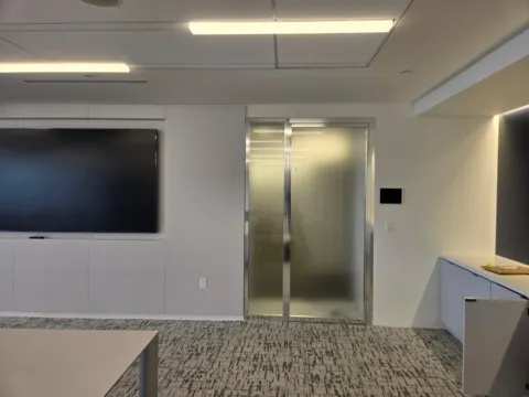 Full-height frosted privacy film installed on a sliding glass office door