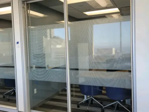Striped privacy film applied across glass meeting room doors