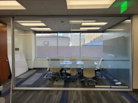 Striped privacy film installed on a glass conference room wall