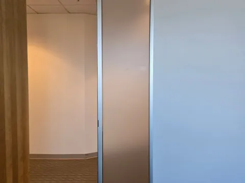 Frosted privacy film applied to a narrow glass office sidelight