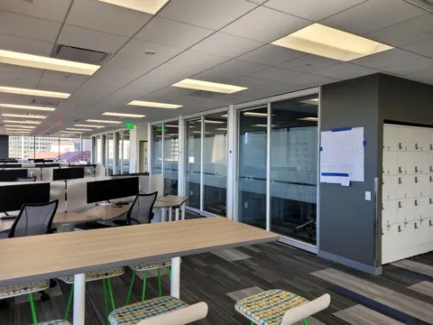 Striped privacy film installed along glass conference rooms in an open office