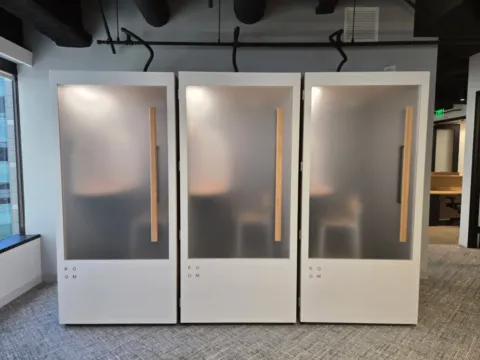Frosted privacy film installed on three workplace privacy booths